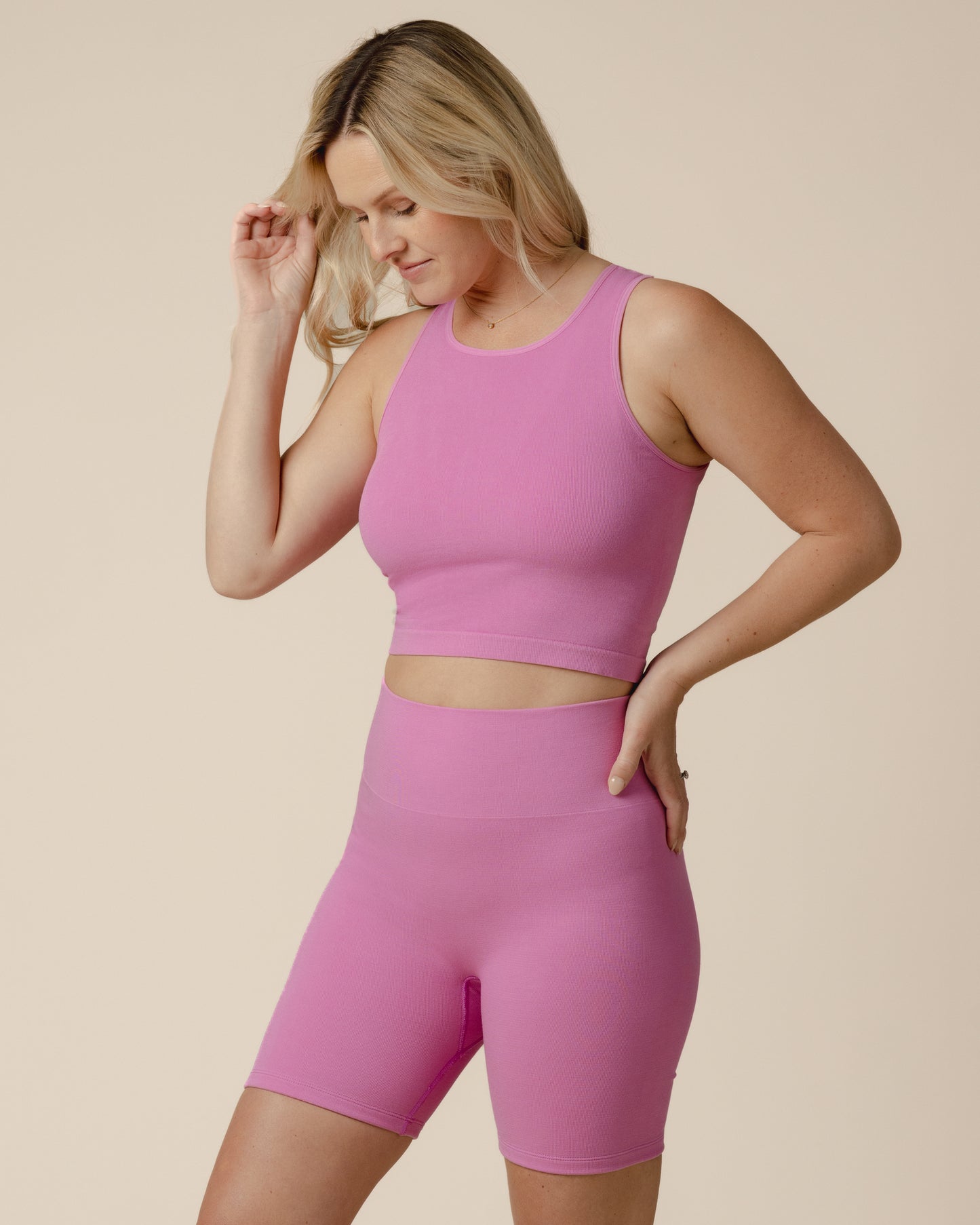 Model wearing the Sublime® Bamboo Maternity & Nursing Longline Bra Top in Soft Fuchsia, paired with matching Sublime® Bamboo Maternity & Postpartum Bike Short