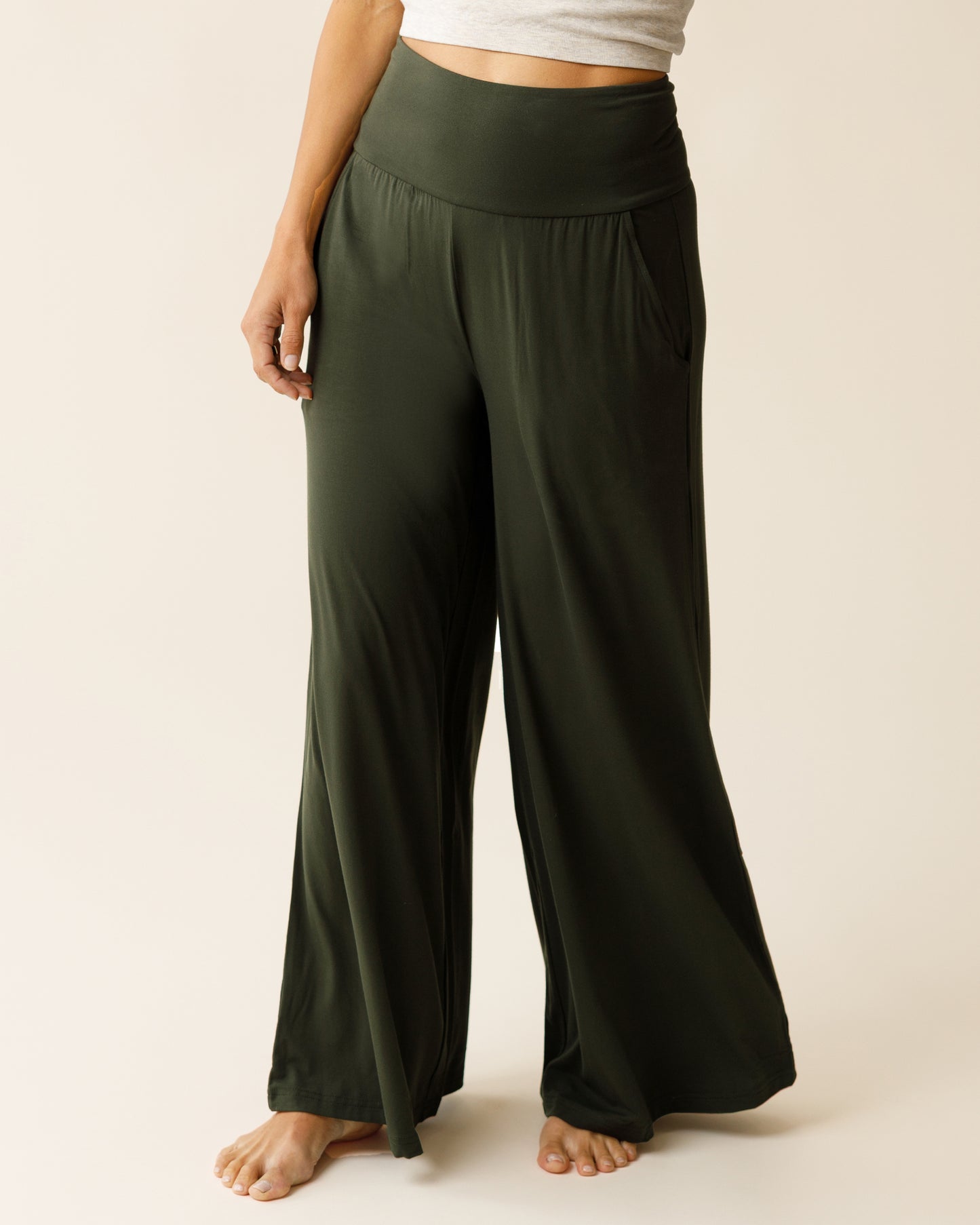 Woman wearing the Bamboo Wide Leg Maternity & Postpartum Lounge Pant in Thyme, showing front of pants