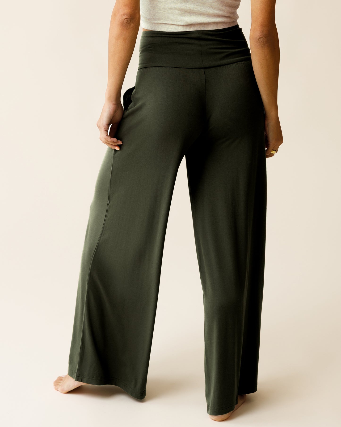 Woman wearing the Bamboo Wide Leg Maternity & Postpartum Lounge Pant in Thyme, showing back of pants