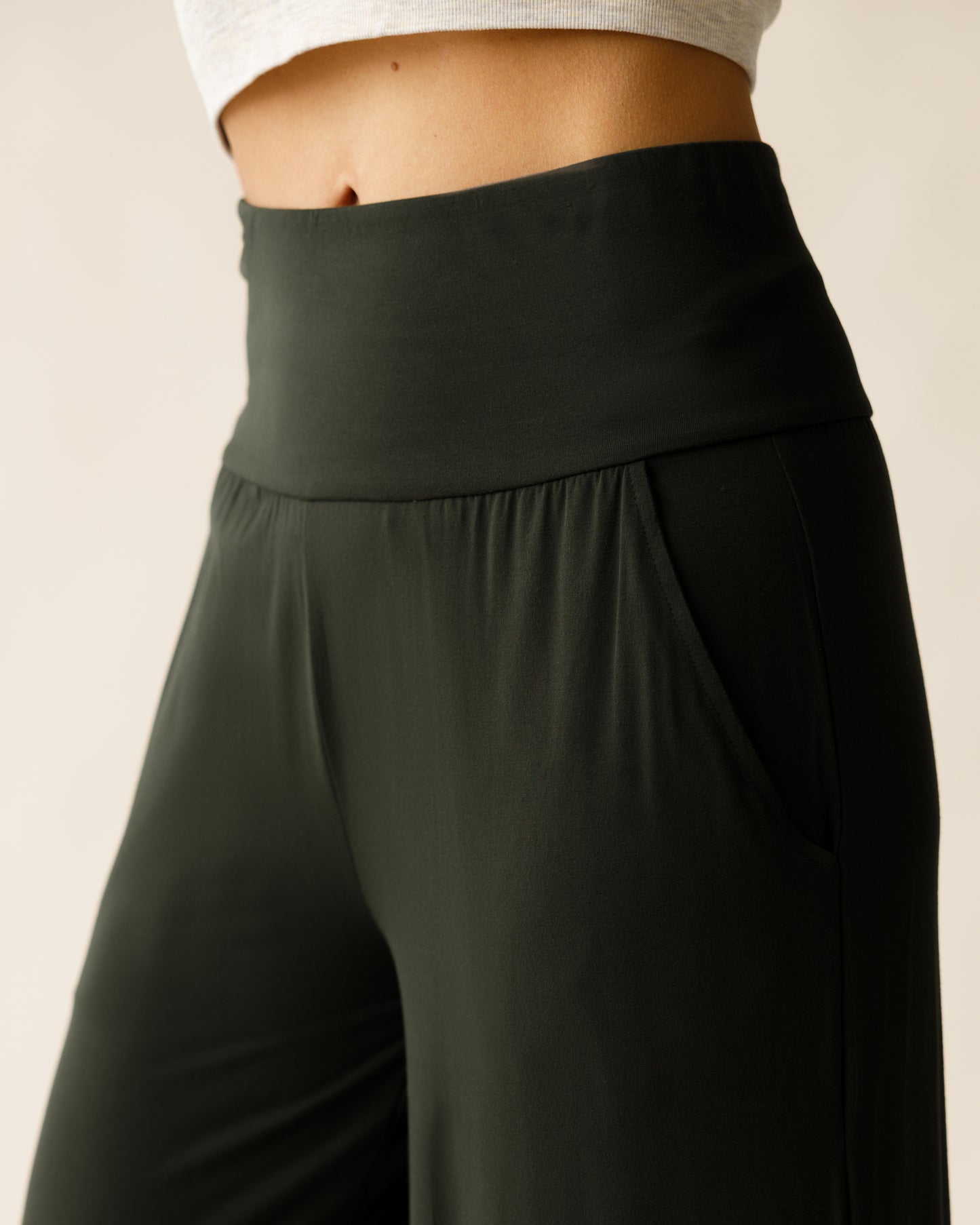 Woman wearing the Bamboo Wide Leg Maternity & Postpartum Lounge Pant in Thyme, showing waistband, pocket, and fabric detail