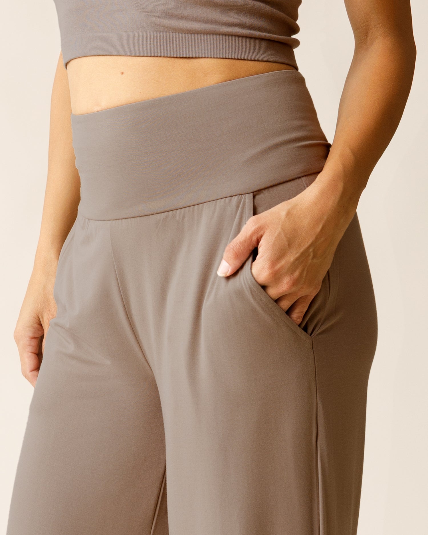 Woman wearing the Bamboo Wide Leg Maternity & Postpartum Lounge Pant in Taupe, showing waistband, pocket, and fabric detail