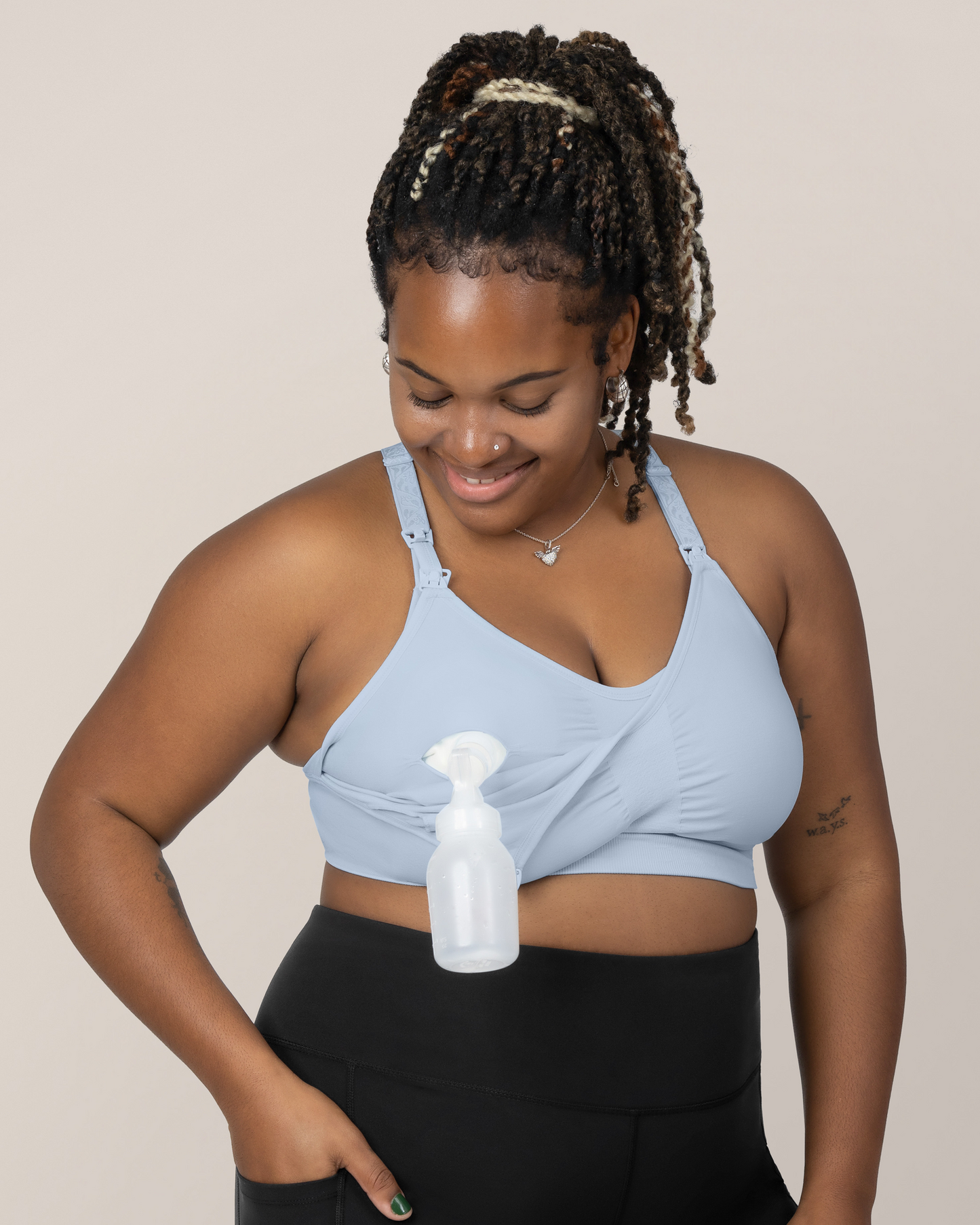 Front view of Model wearing the Sublime® Hands-Free Pumping & Nursing Sports Bra in French Blue while showing the pumping functionality