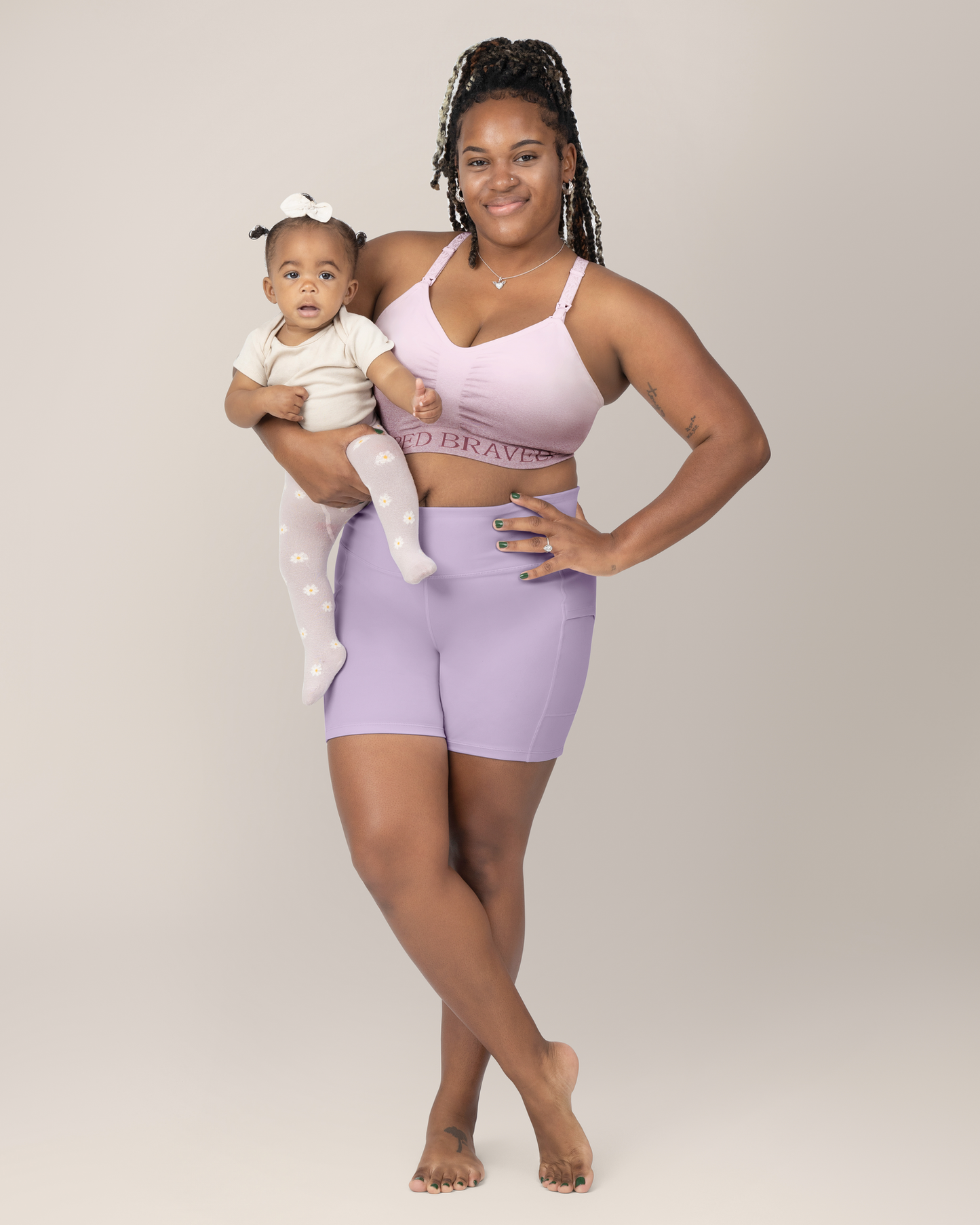 Front view of Model wearing the Stevie Active Postpartum Bike Short in Lavendar with the Sublime Hands Free Pumping and Nursing Sports Bra @model_info:Tonia is wearing an X-Large.