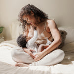 Model wearing the Sublime® Hands-Free Pumping & Nursing Bra, nursing baby on one side and pumping on the other