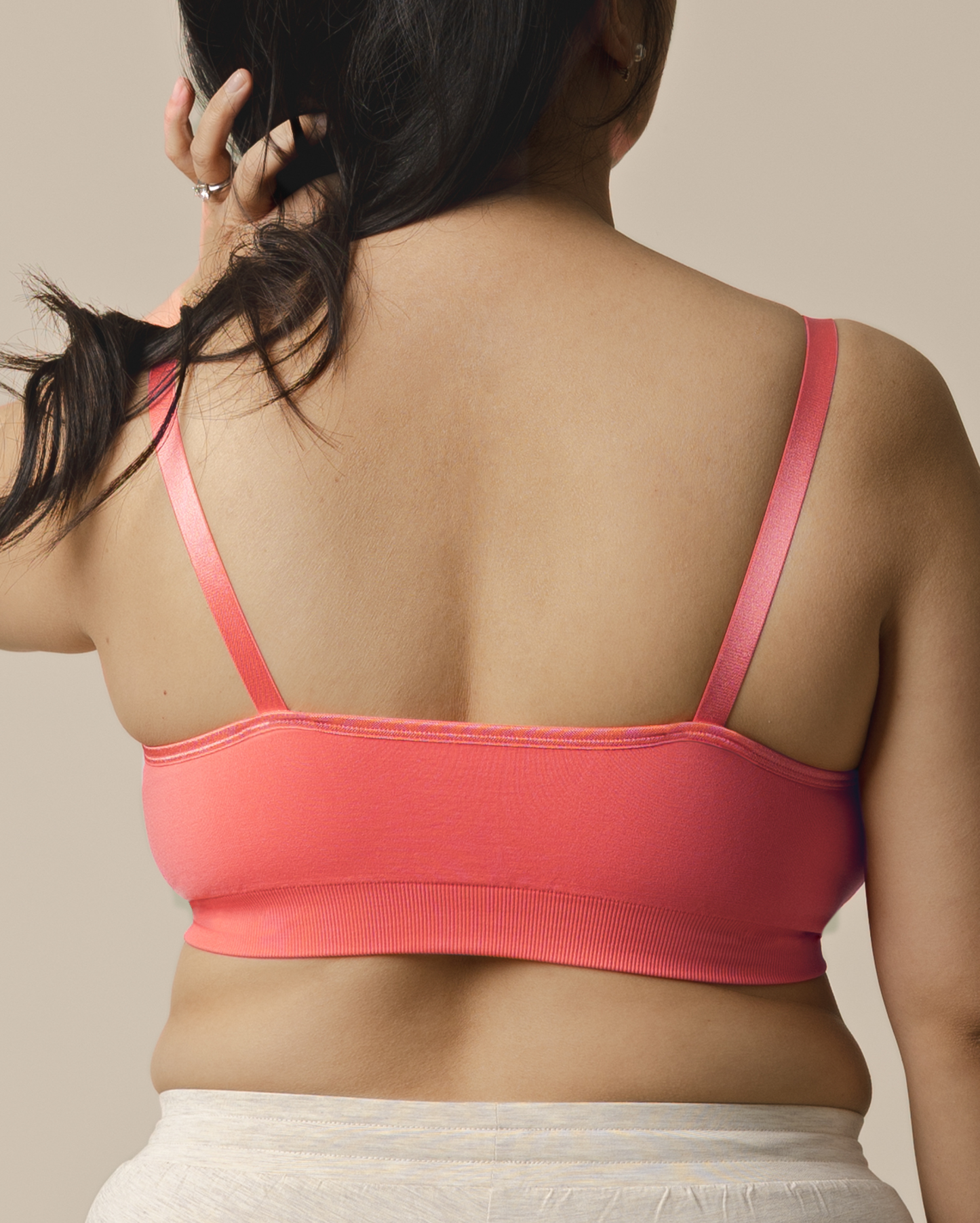 Back view of model wearing the Tatum Seamless Maternity & Nursing Bralette in Coral Sunset