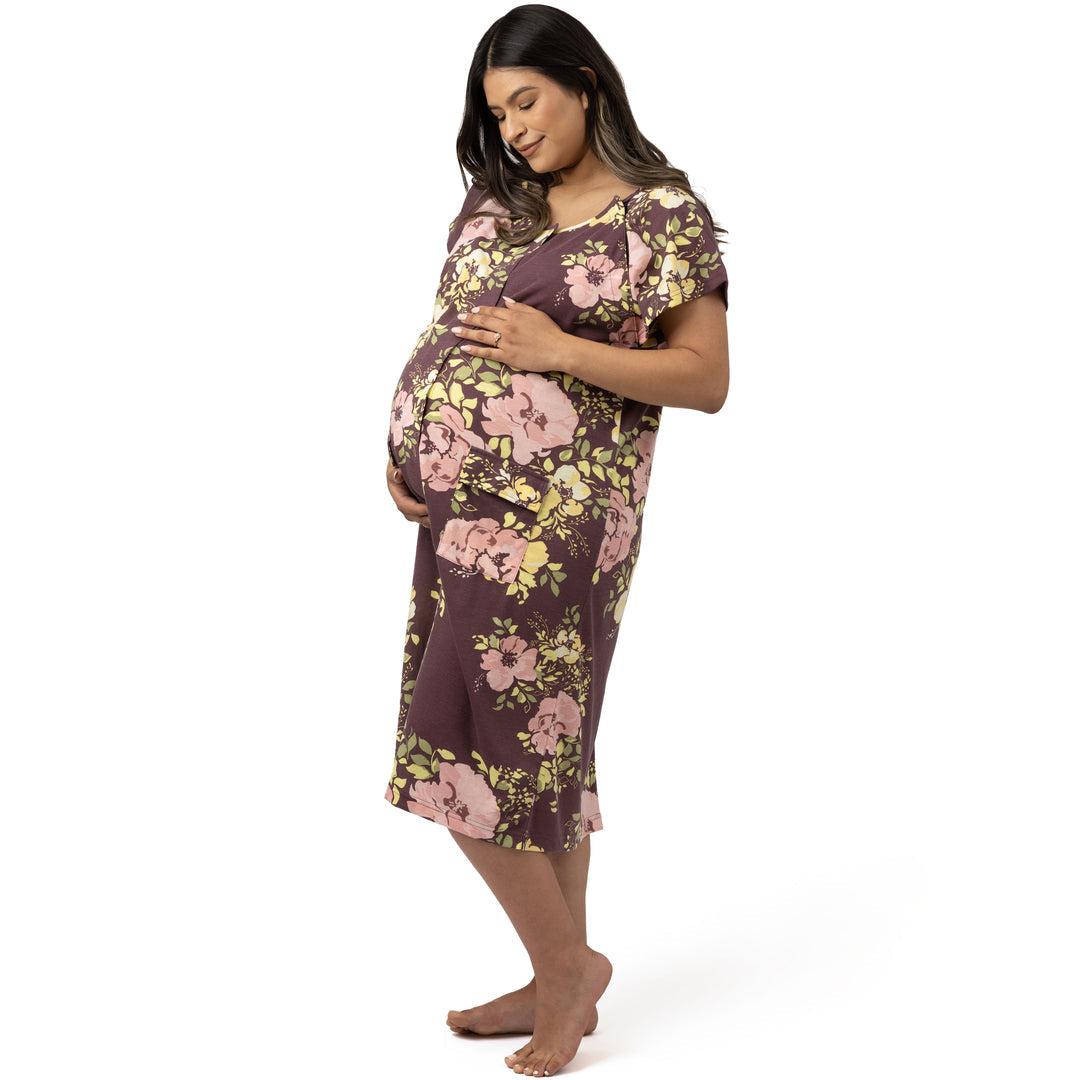 Model wearing the Universal Labor & Delivery Gown in Burgundy Plum Floral holding her pregnant belly. @model_info:Nohely is wearing a S/M/L.