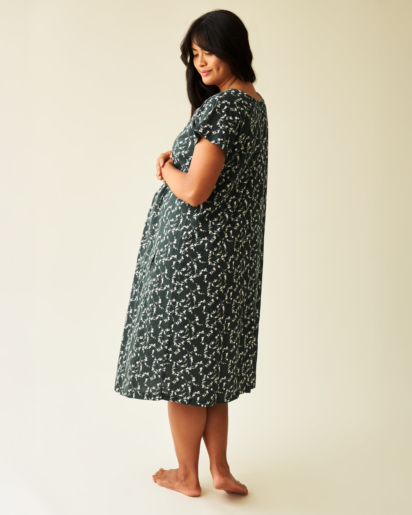 Back view of model wearing Universal Labor & Delivery Gown in Evergreen Blossom