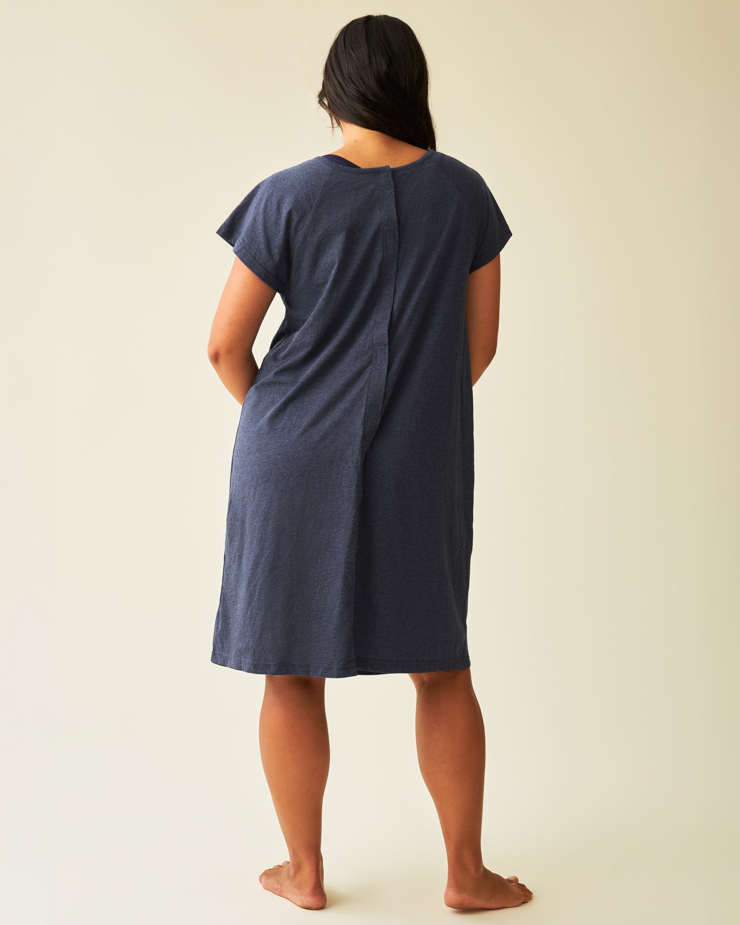 Back view of model wearing Universal Labor & Delivery Gown in Navy Heather