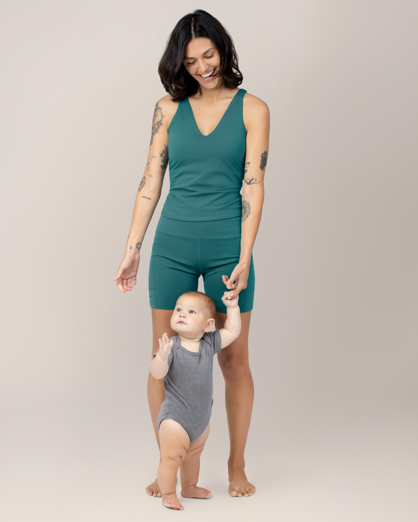 Front view of Model wearing the Wren Active V-Neck Nursing Tank Top in Teal with matching Stevie Active Postpartum Bike Short