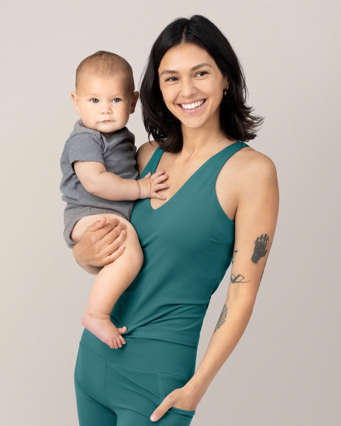 Side view of Model wearing the Wren Active V-Neck Nursing Tank Top in Teal