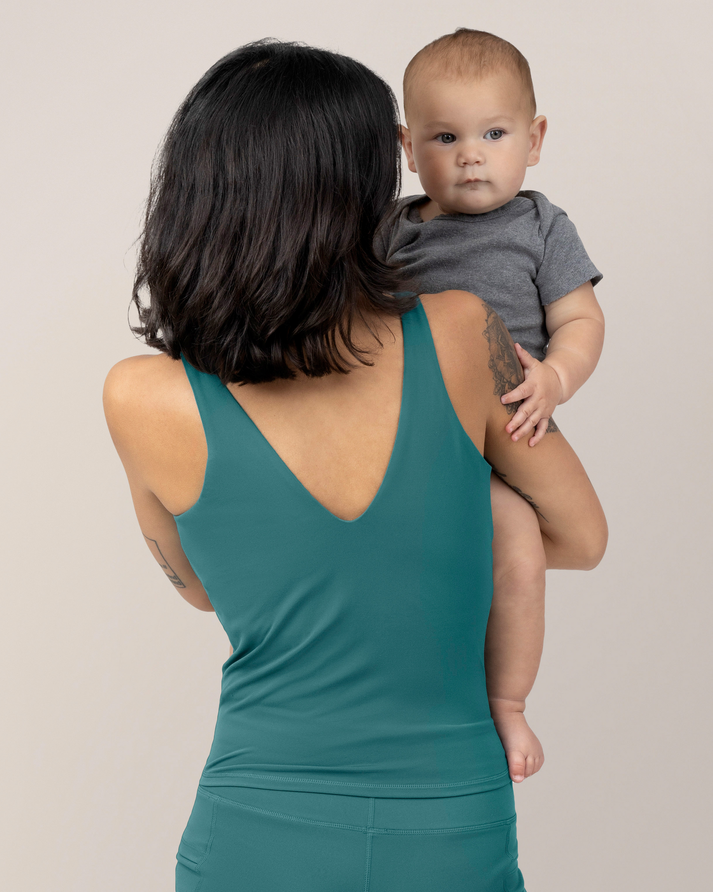 Back view of Model wearing the Wren Active V-Neck Nursing Tank Top in Teal