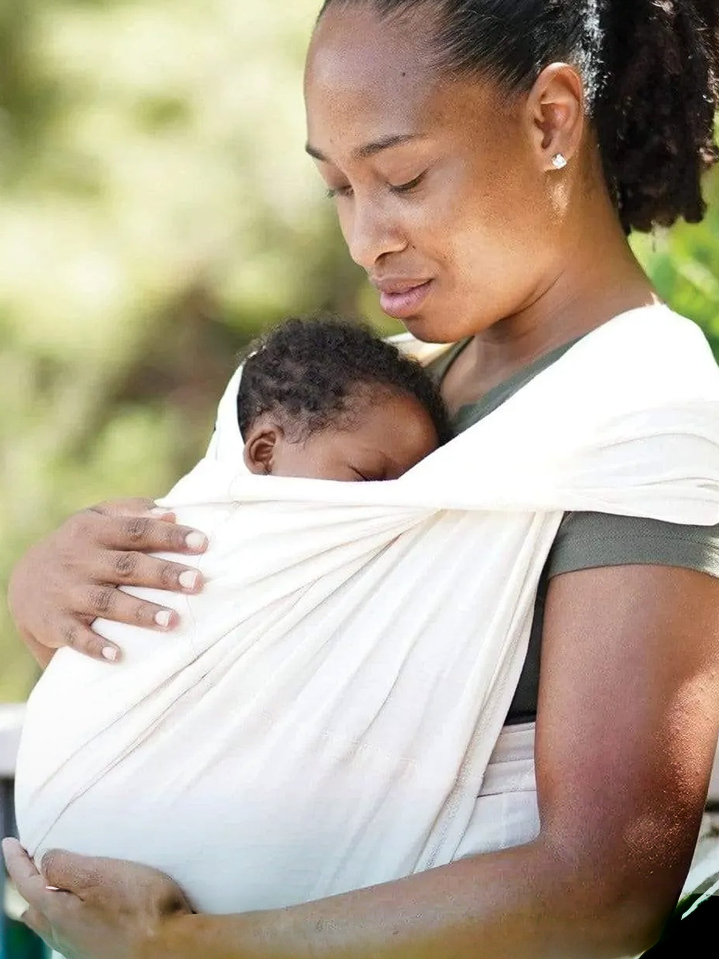 Model wearing baby in the Baby K'tan Organic Baby Carrier in Natural