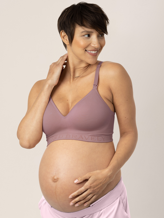 Pregnant model wearing the Signature Sublime® Contour Maternity & Nursing Bra in Twilight with her hand on her baby bump. @model_info:Briana is wearing a Small.