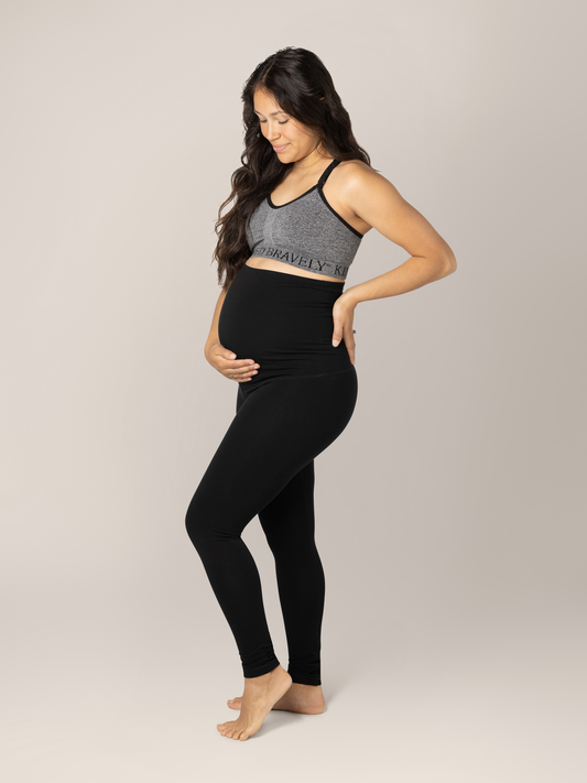 Side view of model wearing the Cotton Maternity & Postpartum Footless Tight in black, with Sublime® Nursing Sports Bra in heather grey @model_info:Desiree is 5'3" and wearing a Small.