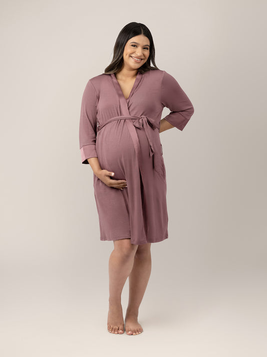 Pregnant model wearing the Emmaline Robe in Twilight with her hand on her stomach. @model_info:Nohely is wearing a L/XL.