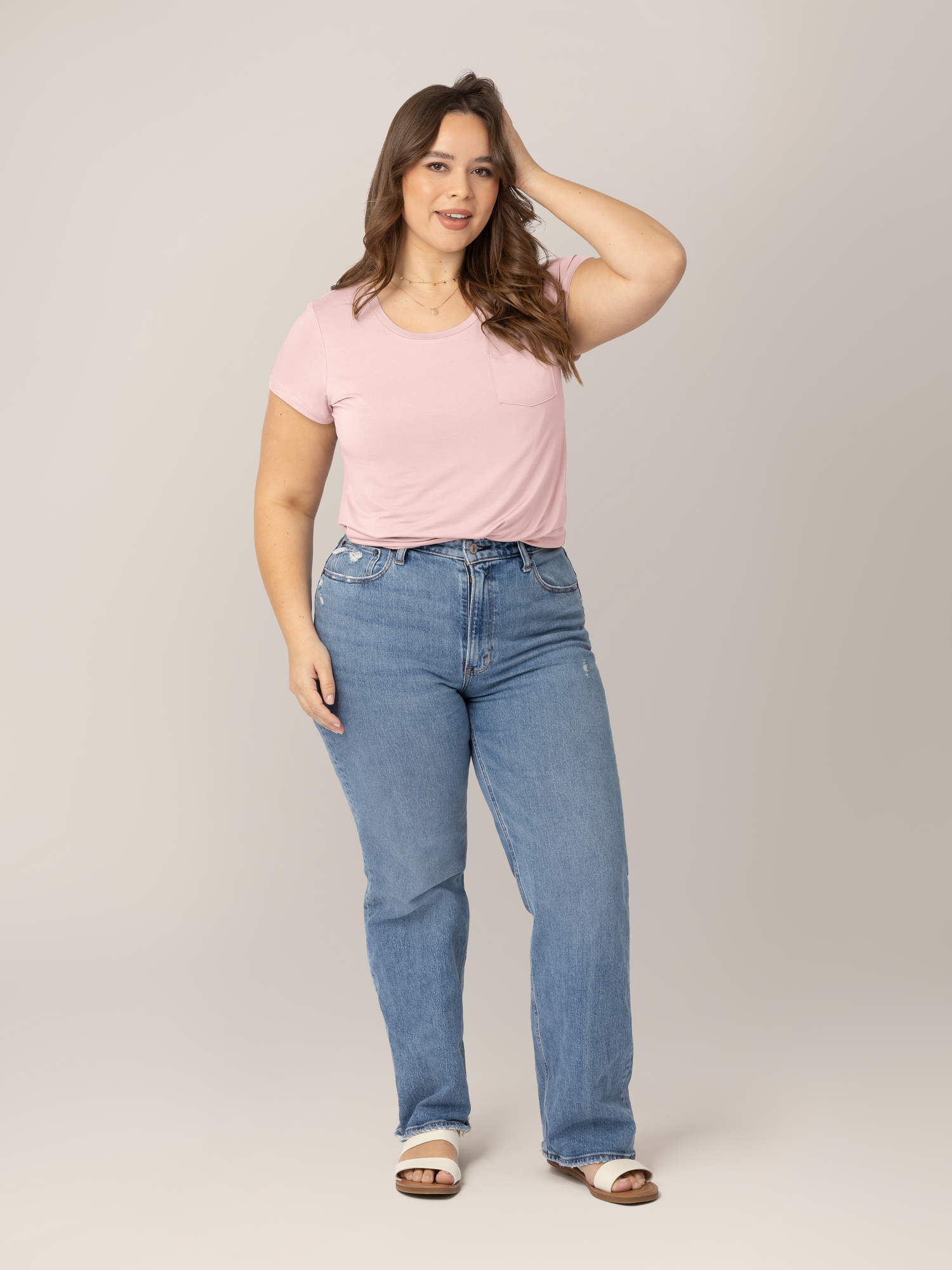 Model wearing the  Everyday Maternity & Nursing T-shirt in Dusty Pink with her hand in her hair. 