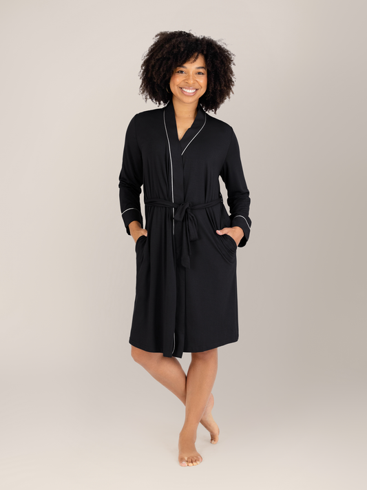 Model wearing the Clea Bamboo Robe in Black with her hands in the pockets. @model_info:Tess is 5'5" and wearing a S/M.