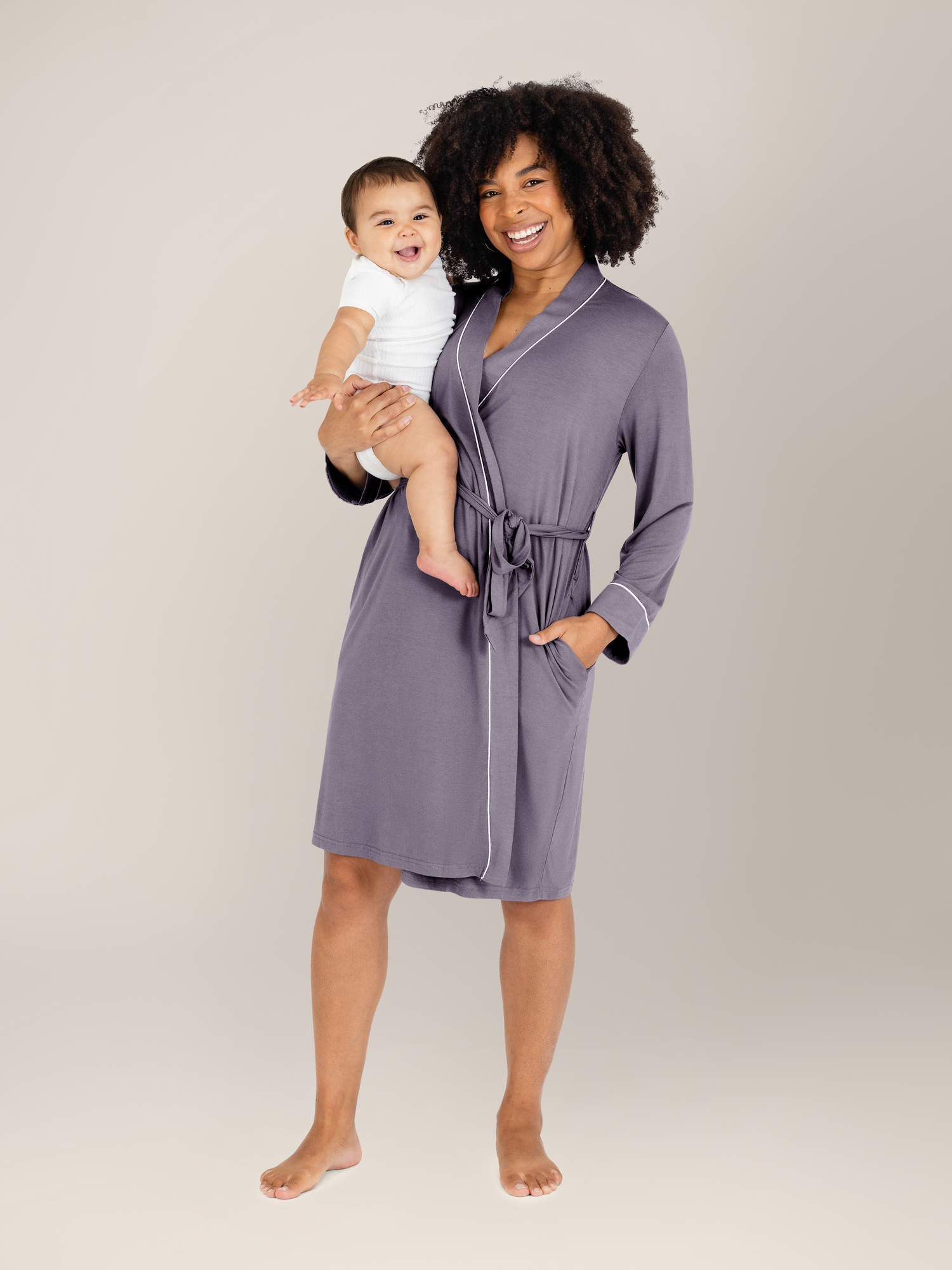 Model with her baby on her hip wearing the Clea Bamboo Robe in Granite. @model_info:Tess is 5'5" and wearing S/M.