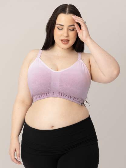 Model wearing the Sublime® Hands-Free Pumping & Nursing Sports Bra  in Ombre Purple with her hand on her hair. @model_info:Rachel is wearing a X-Large Busty.
