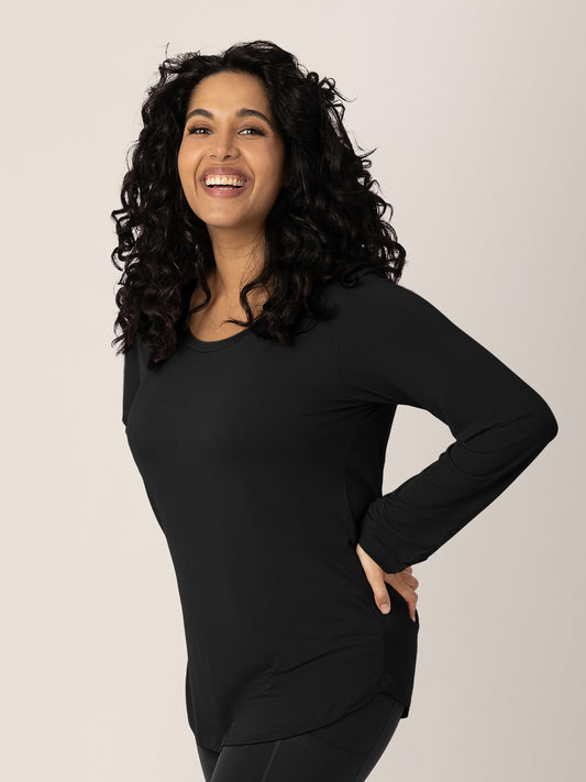 Model wearing the Bamboo Maternity & Nursing Long Sleeve T-Shirt in Black with her hands on her hips. @model_info:Zakeeya is wearing a Small.