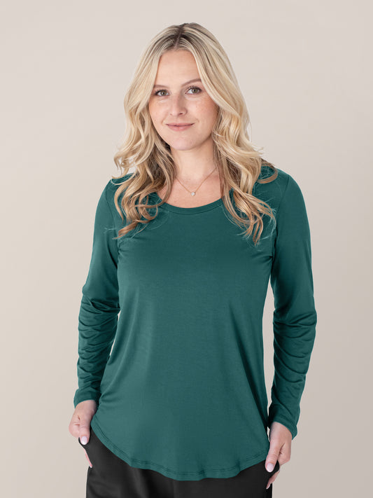 Model wearing the Bamboo Maternity & Nursing Long Sleeve T-shirt in Evergreen with her hands at her sides. @model_info:Maddy is wearing a Small.