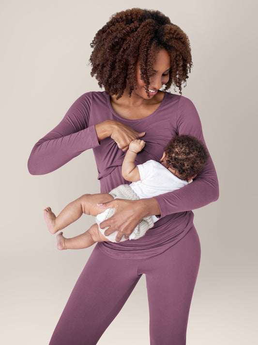 Model breastfeeding her baby while wearing the Jane Nursing Pajama Set in Burgundy Plum. @model_info:Elaina is 5'9" and wearing a Small.