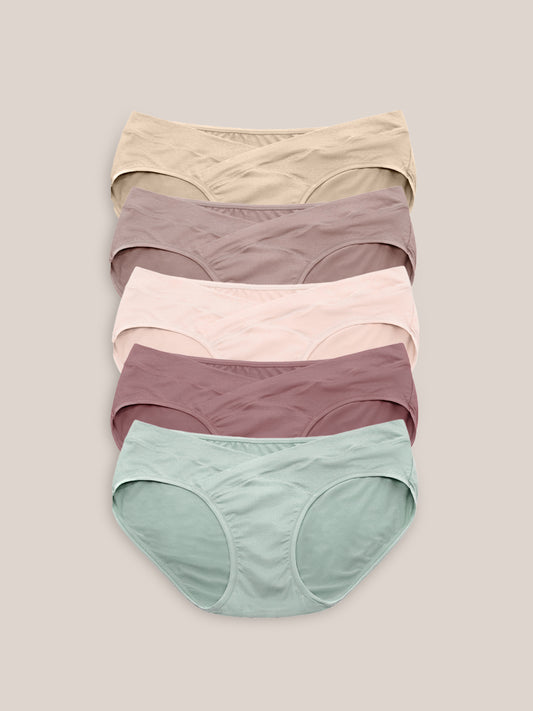 Flat lay of the Under-the-Bump Bikini Underwear Pack | Low Rise Style - Assorted against a griege background. 