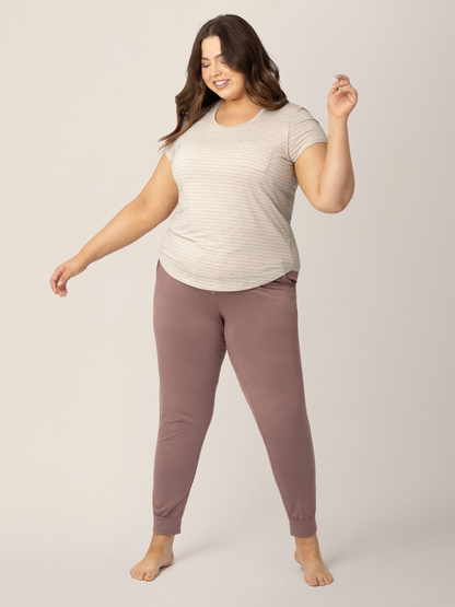 Model wearing the Everyday Maternity & Nursing T-shirt in Oatmeal Stripe with her hands outstretched. @model_info:Bailey is wearing an X-Large.