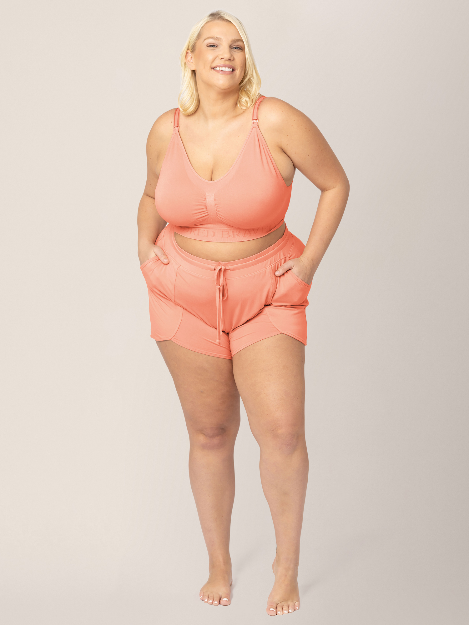 Front view of model wearing the Bamboo Maternity & Postpartum Lounge Shorts in vintage coral paired with matching Bamboo Lounge Around Nursing & Maternity Tank @model_info:Lauren is wearing an X-Large.