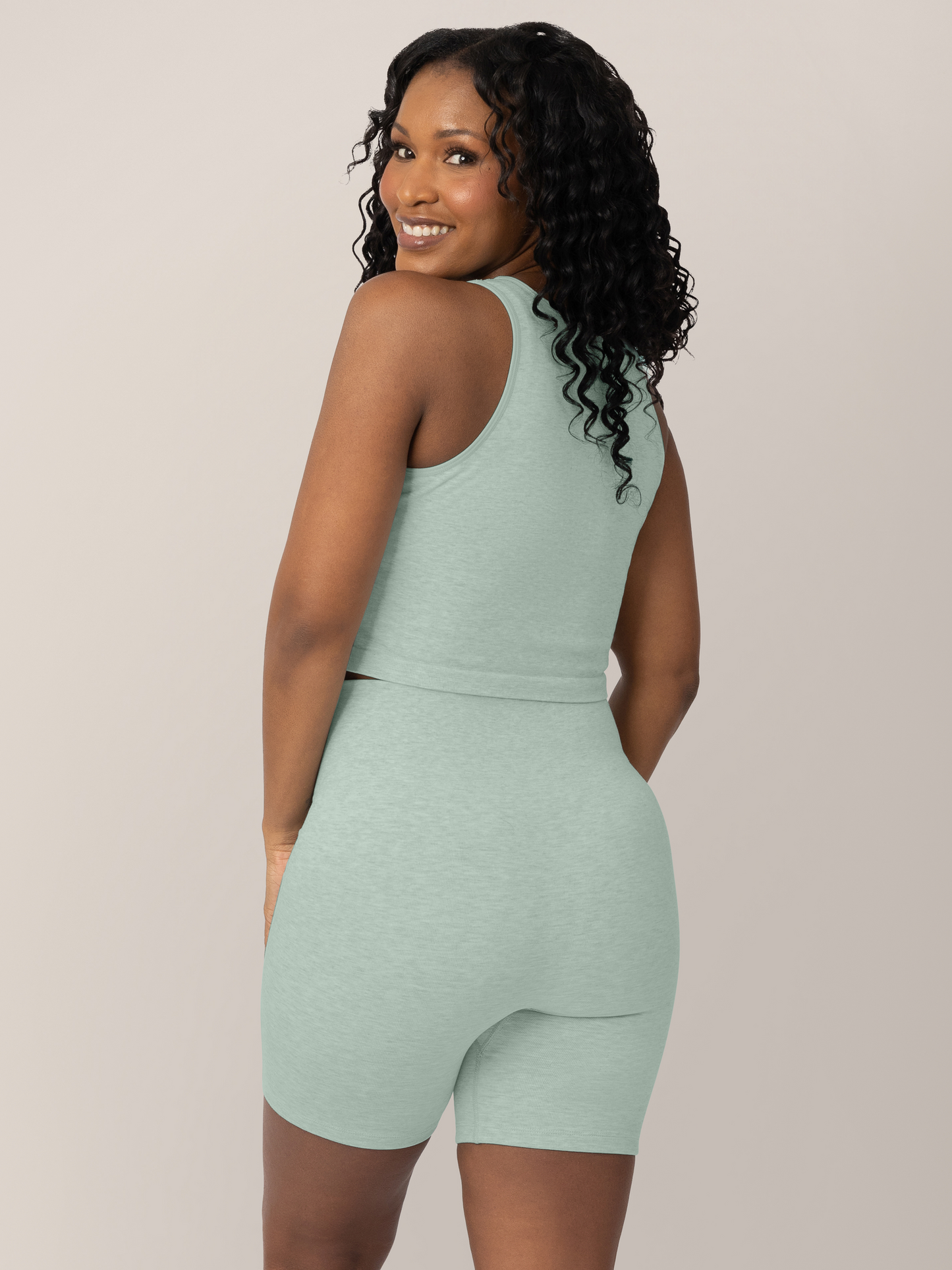 Back view of model  wearing the Sublime® Bamboo Maternity & Postpartum Bike Short in Dusty Blue Green Heather, paired with the matching Sublime® Bamboo Maternity & Nursing Longline Bra