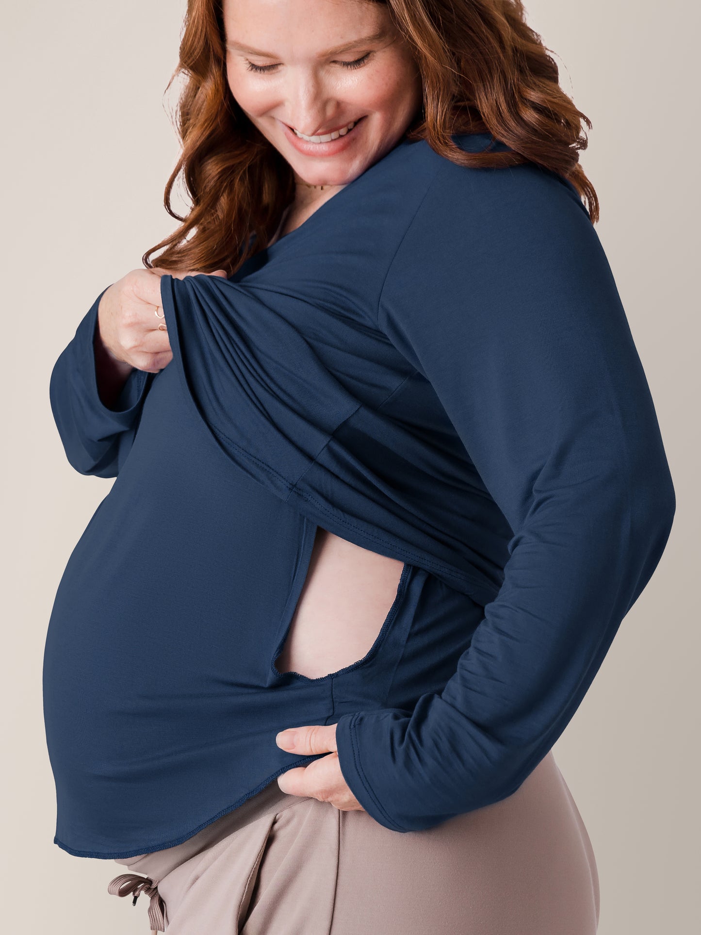 Pregnant model lifting up the nursing panel on the Bamboo Maternity & Nursing Long Sleeve T-shirt in Navy 
