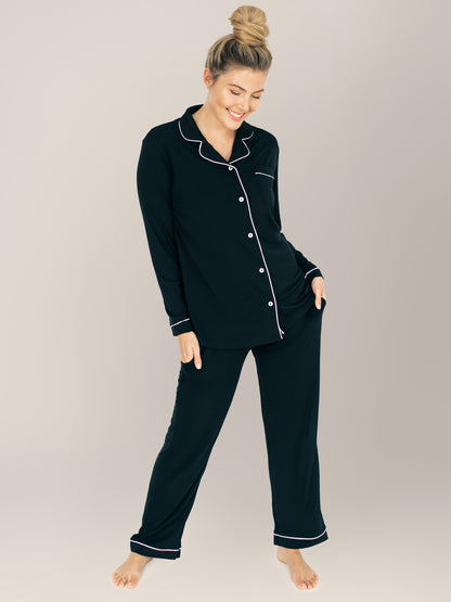 Model looking down at the ground while wearing the Clea Bamboo Long Sleeve Pajama Set in Black