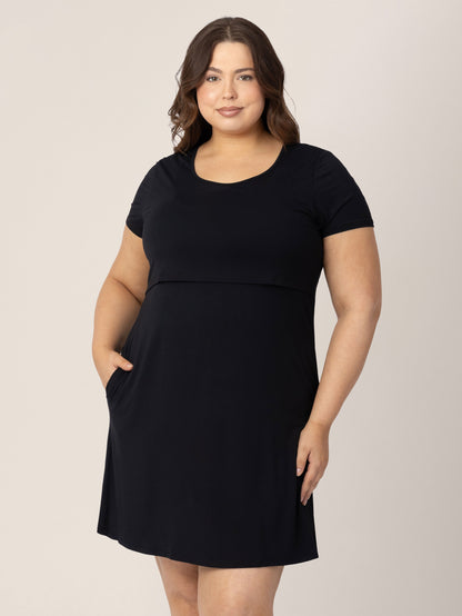 Model wearing the Eleanora Bamboo Maternity & Nursing Dress in Black with her hand in her pocket.
