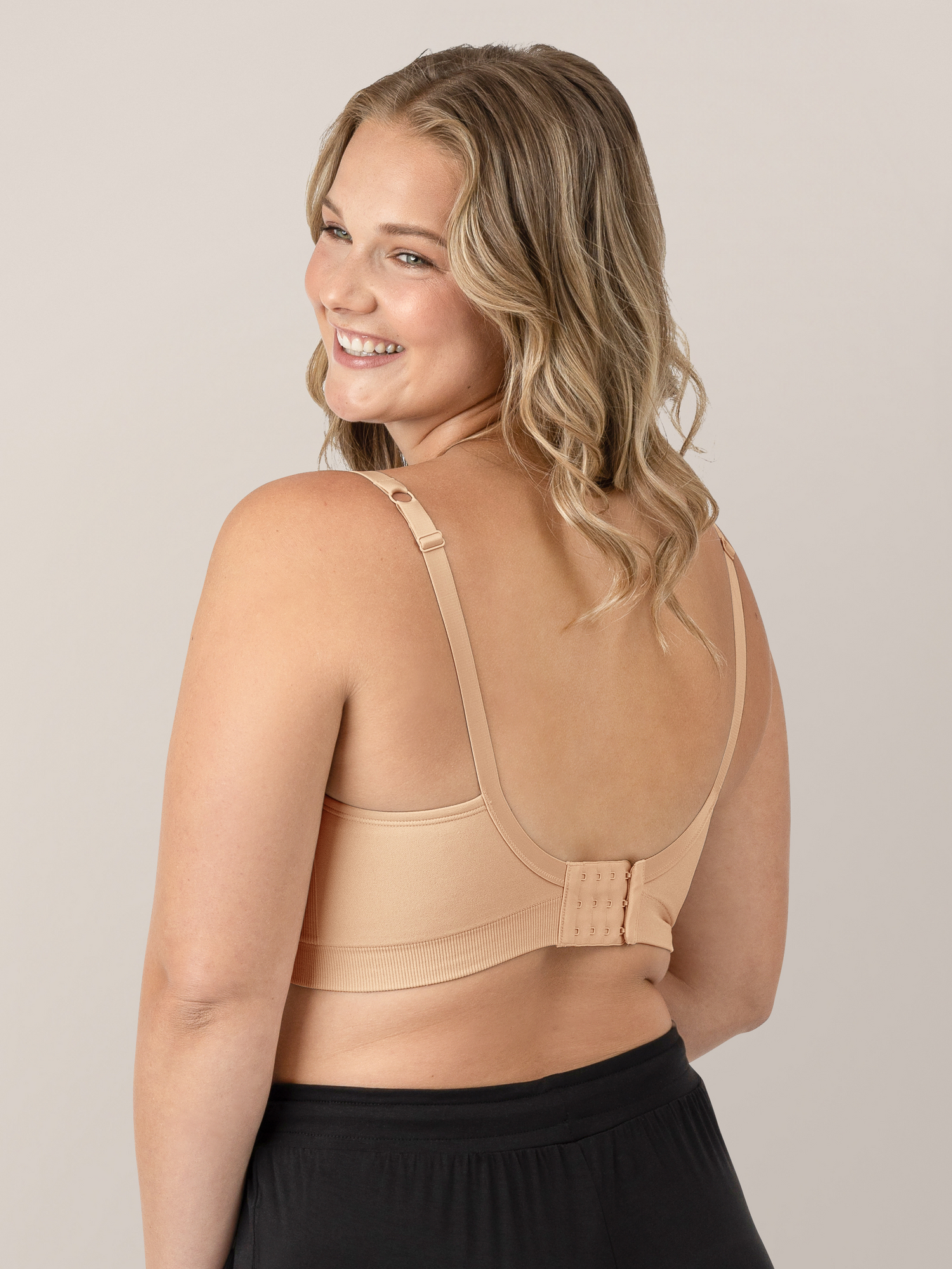 Back view of a model wearing the Everly Wireless Contour Bra  in Beige.