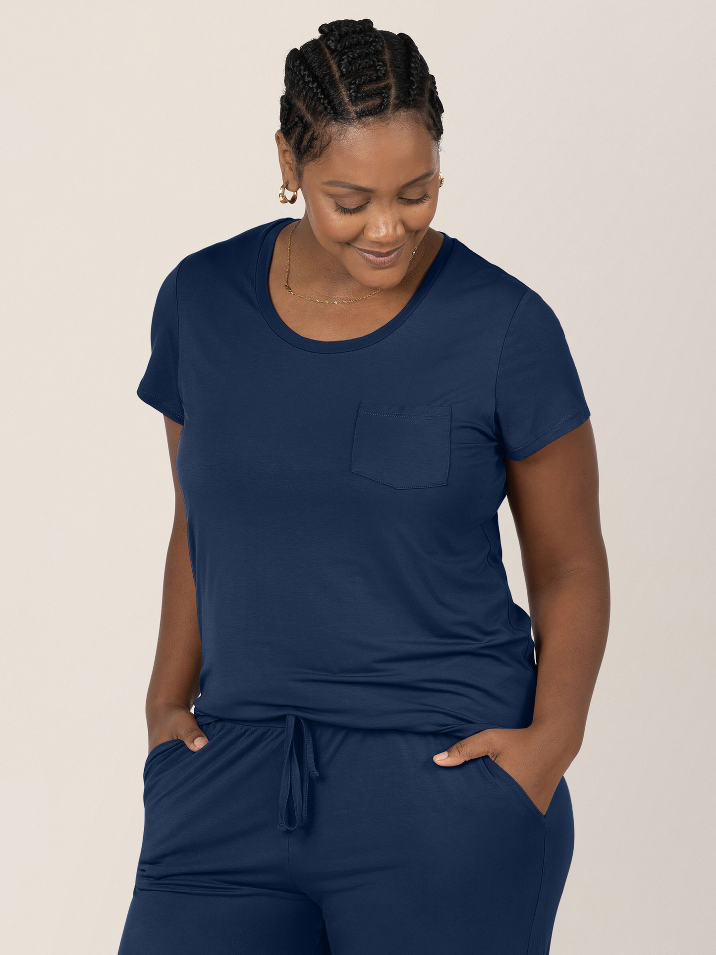 Model looking down with her hands in her pant pockets while wearing the Everyday Maternity & Nursing T-shirt in Navy