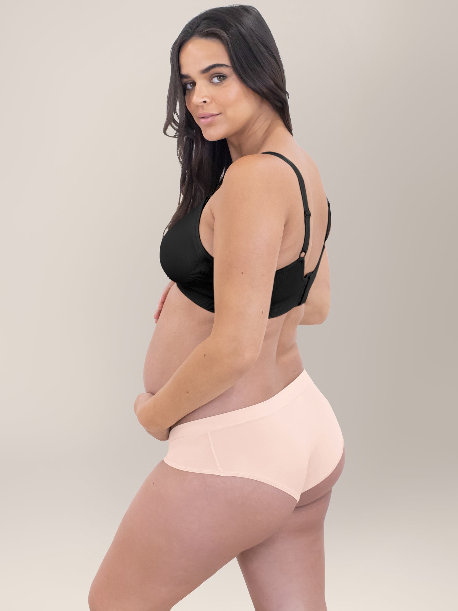 Side view of a pregnant model wearing the Grow with Me™ Maternity & Postpartum Hipster in Soft Pink. @model_info:Brooklyn is wearing a Small.