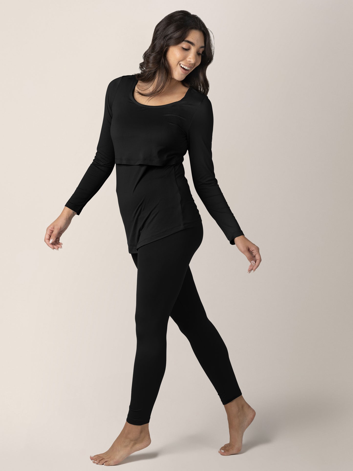 Model wearing the Jane Nursing Pajama Set in Black looking behind her. 