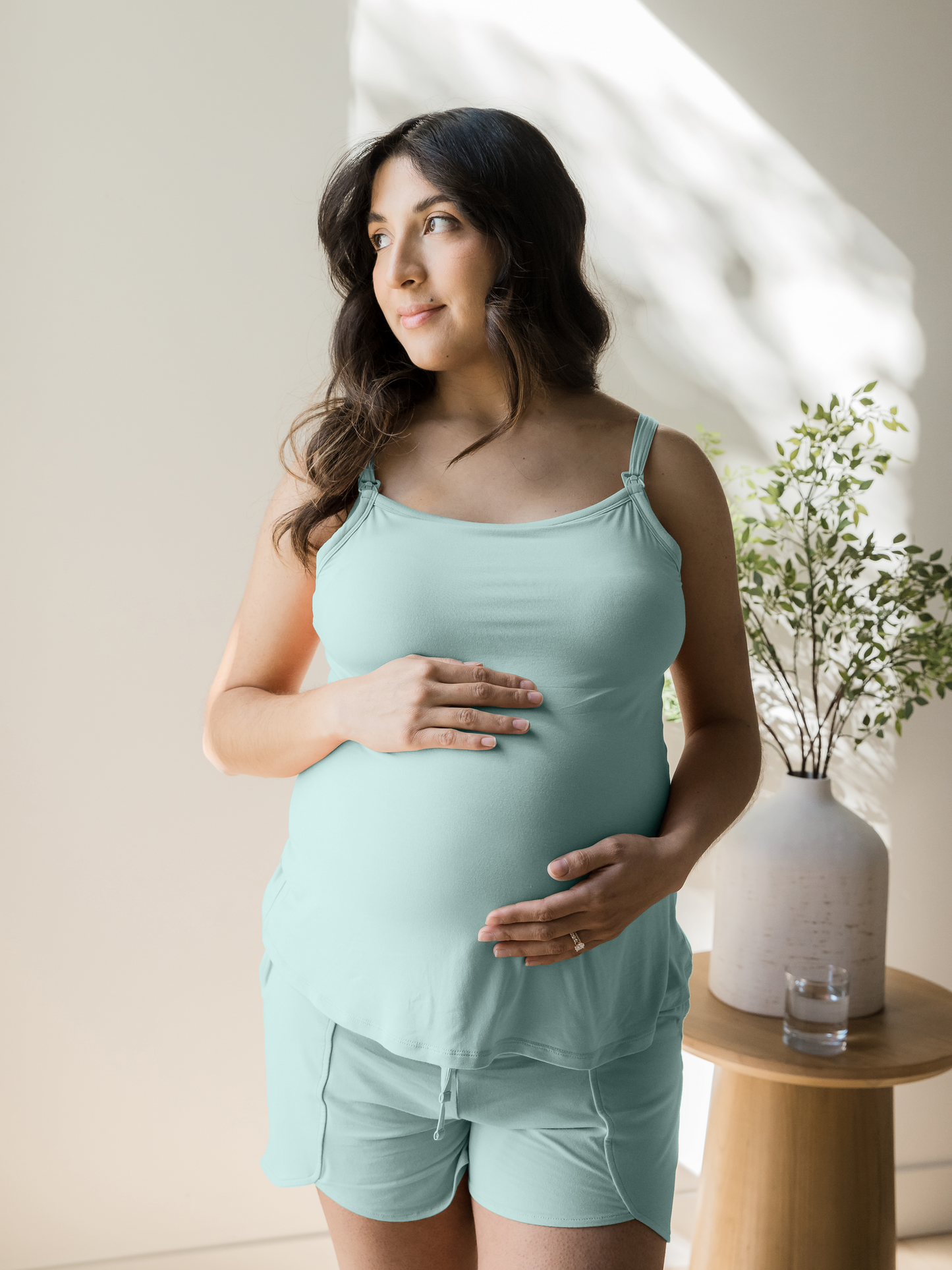 Model wearing the Bamboo Lounge Around Nursing Tank in Dusty Blue Green holding her belly.