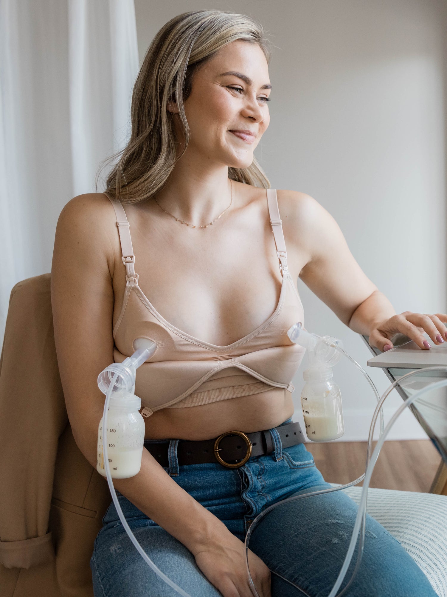 Model pumping while hooked up to the Signature Sublime® Contour Maternity & Nursing Bra in Beige
