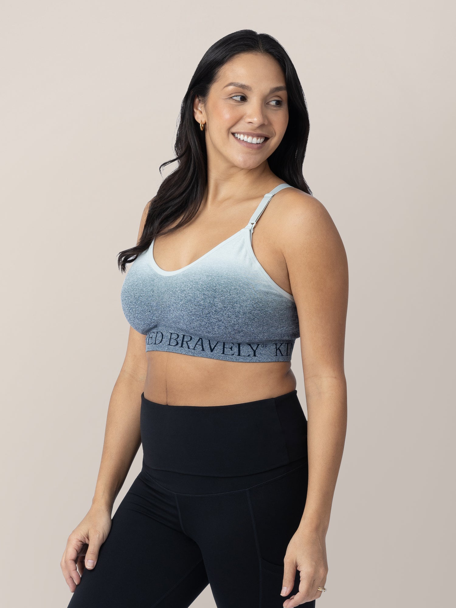 Model wearing the Sublime® Nursing Sports Bra in Ombre storm, looking over her shoulder.