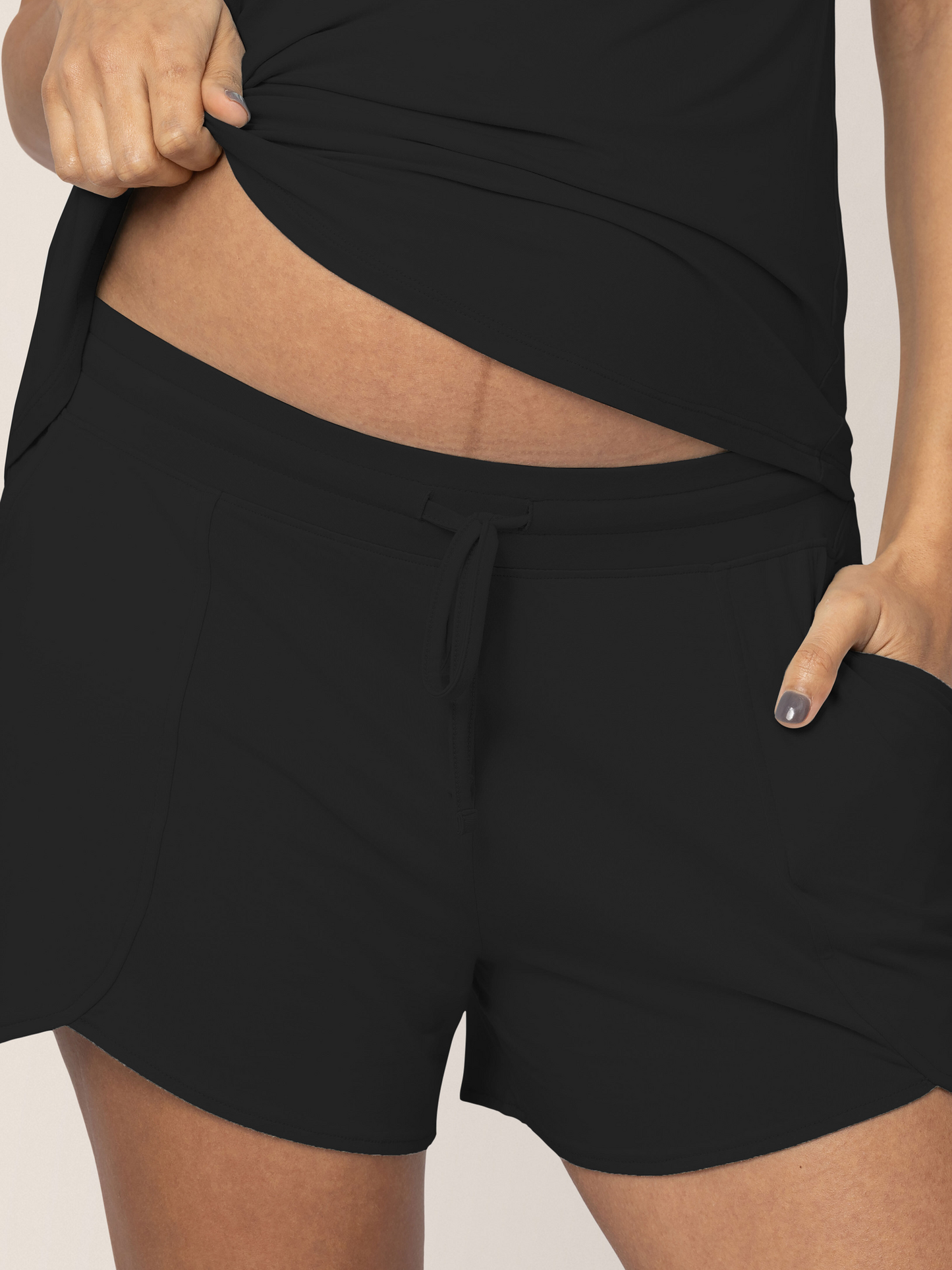 Closeup of a pregnant model wearing the Bamboo Maternity & Postpartum Lounge Short in Black