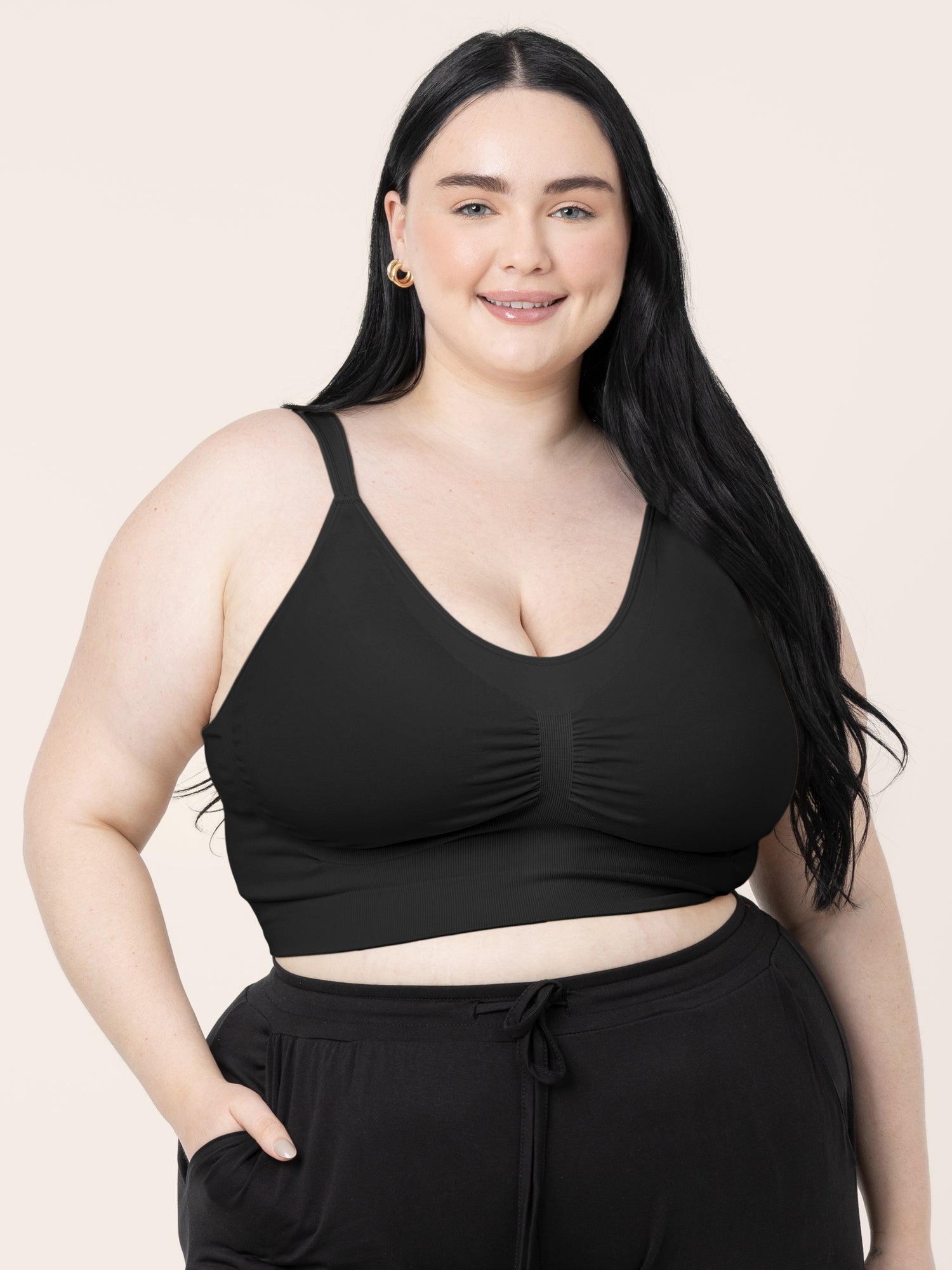 Model wearing the Nellie Sublime® Wireless Bra in Black with her hand in her pocket. @model_info:Kenna is wearing a 2X Busty.