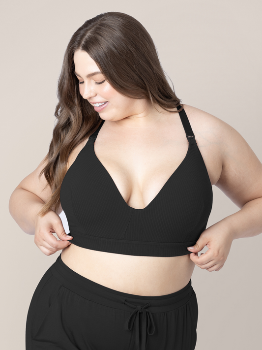 Model wearing the Ribbed Cotton Maternity & Nursing Bra in Black. @model_info:Bailey is wearing an X-Large Busty.