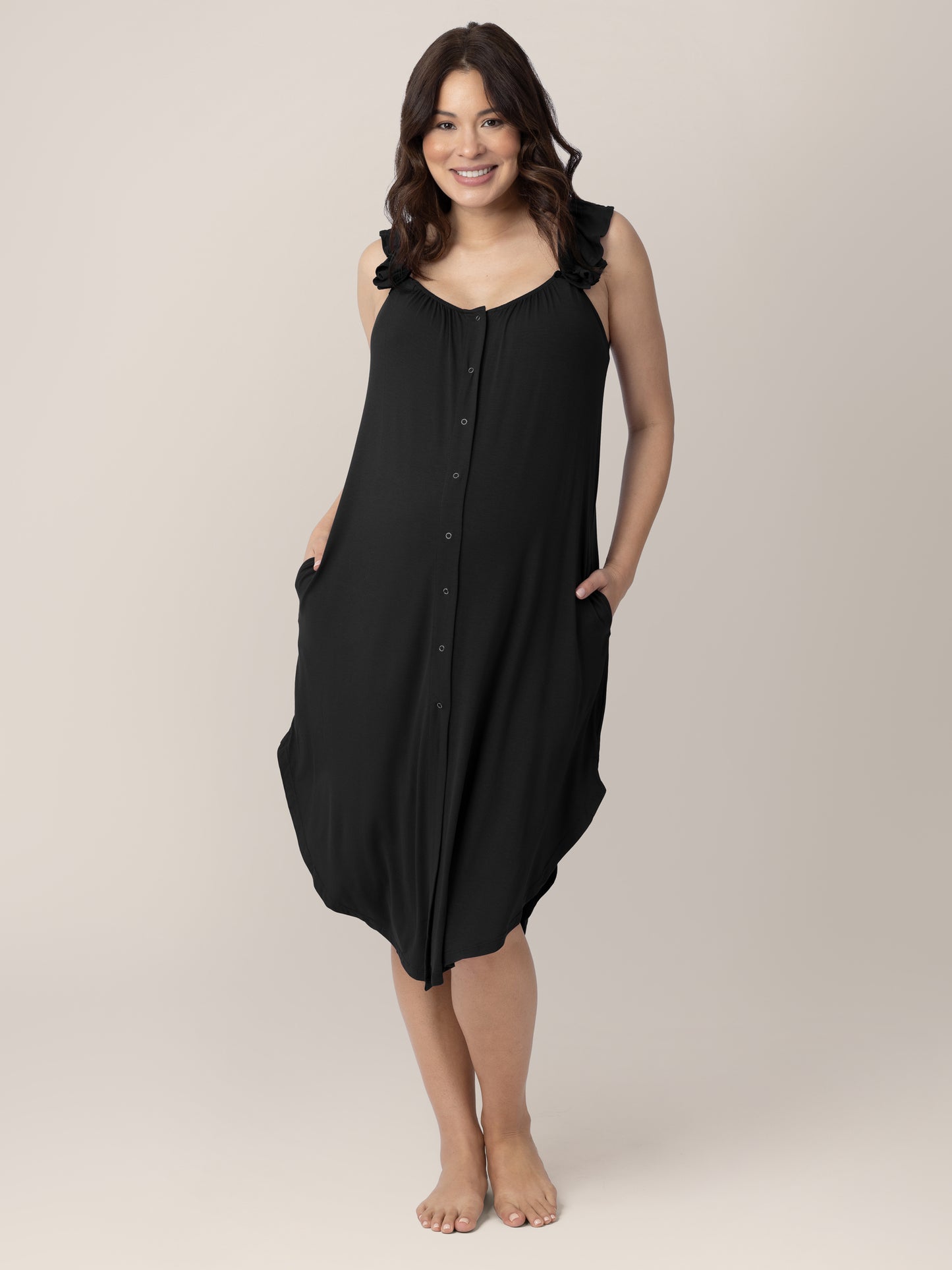 Front view of a pregnant model wearing the Ruffle Strap Labor & Delivery Gown in Black