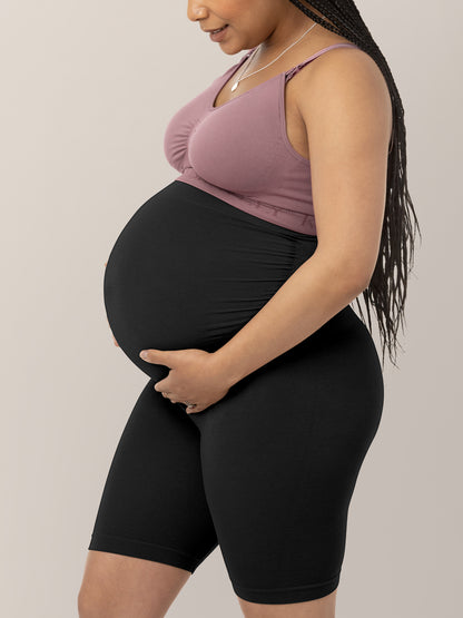 Side view of a pregnant model wearing the Seamless Bamboo Maternity Thigh Savers in Black