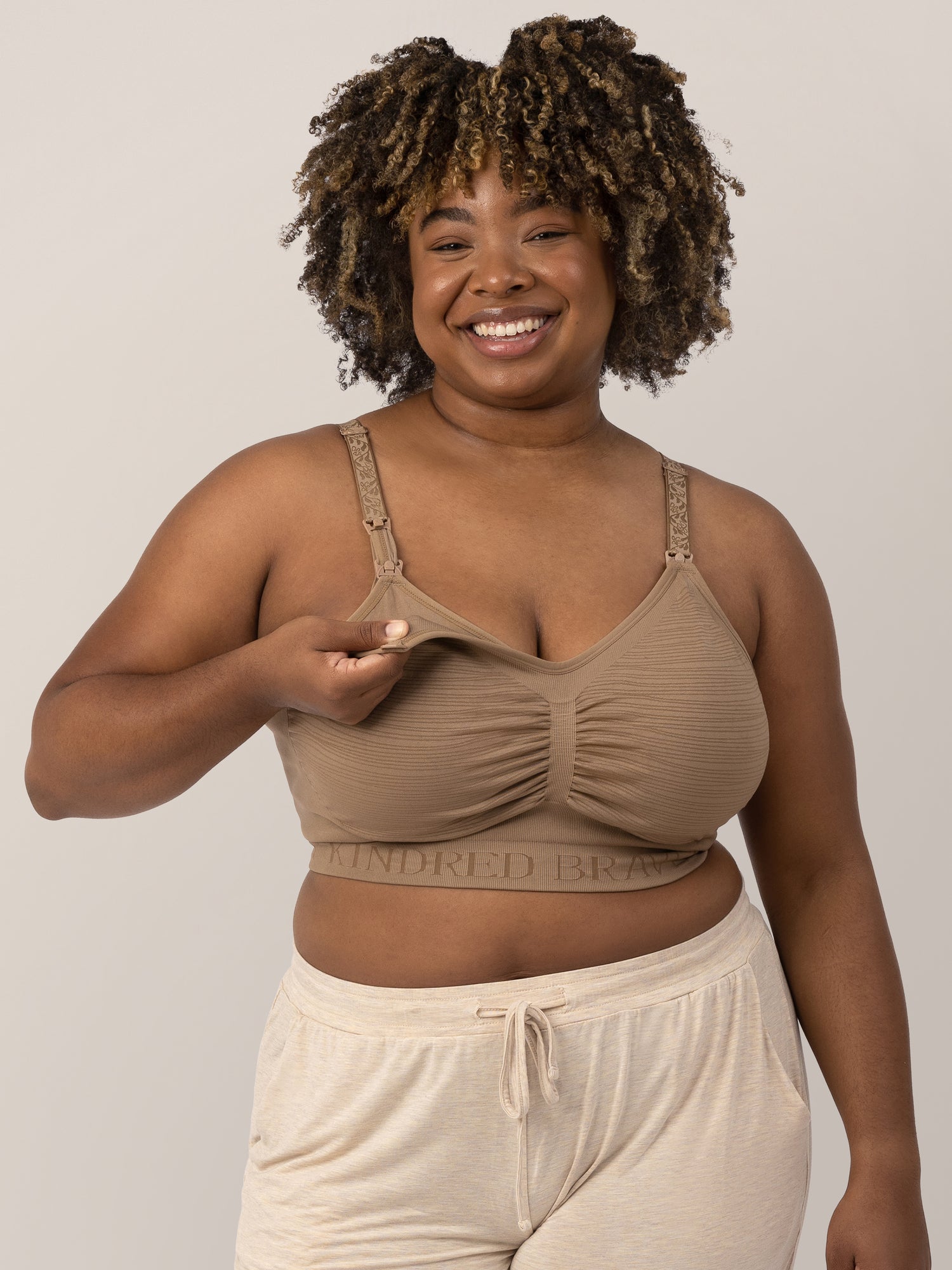 Model wearing the Sublime® Hands-Free Pumping & Nursing Bra in Latte showing the clip down nursing and pumping access