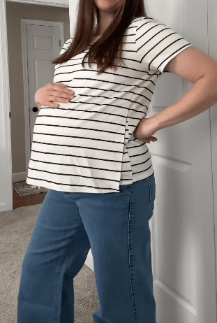 Rotating video of a pregnant woman wearing both the Relaxed Cotton Maternity & Nursing T-shirt in White & Black Stripe and Relaxed Cotton Maternity & Nursing T-shirt in White, with the Wide Leg Maternity & Postpartum Jean in Medium Wash, in a light filled bedroom.