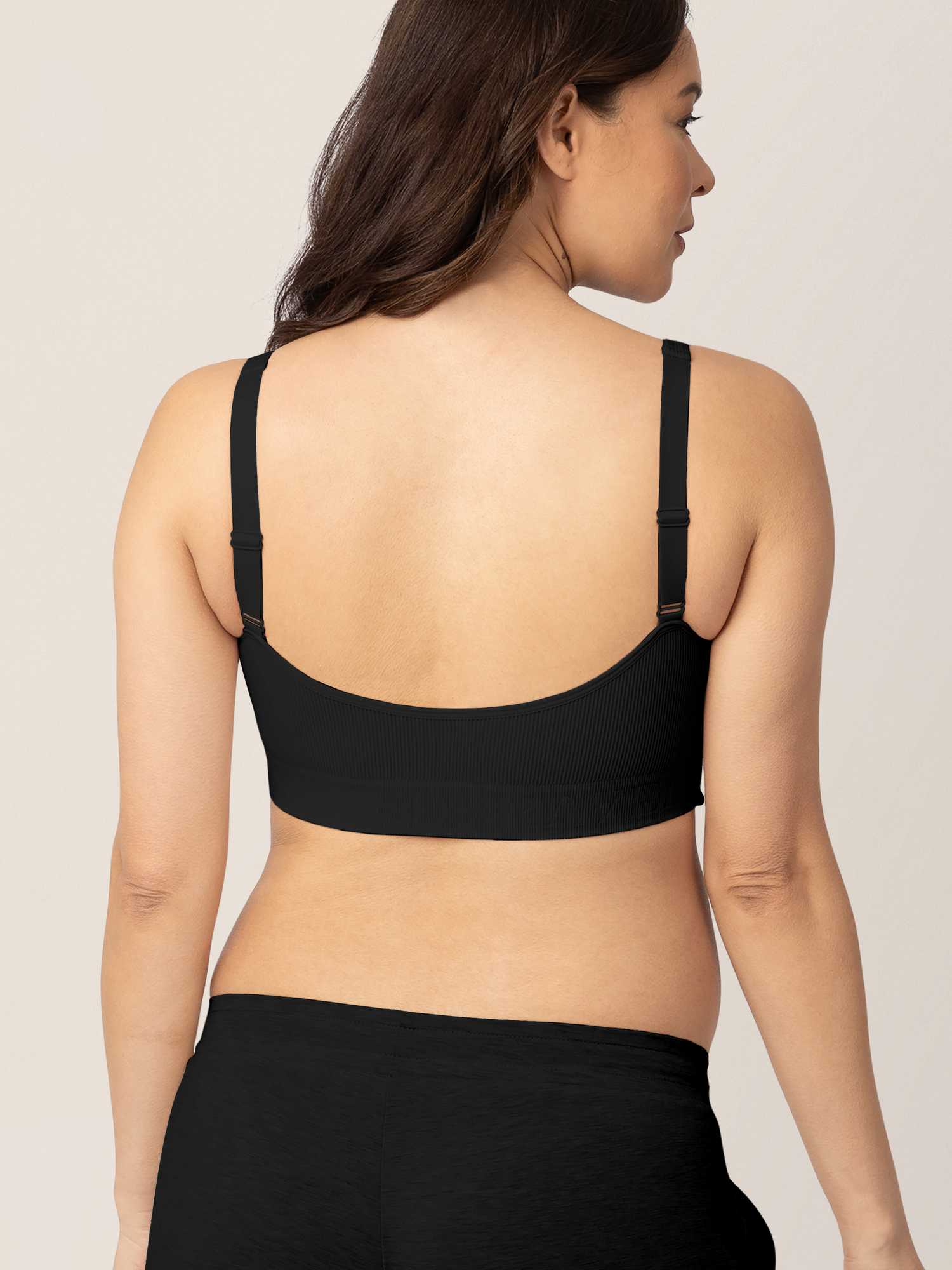 Back of a Pregnant model wearing the Sublime® Adjustable Crossover Nursing & Lounge Bra in Black.