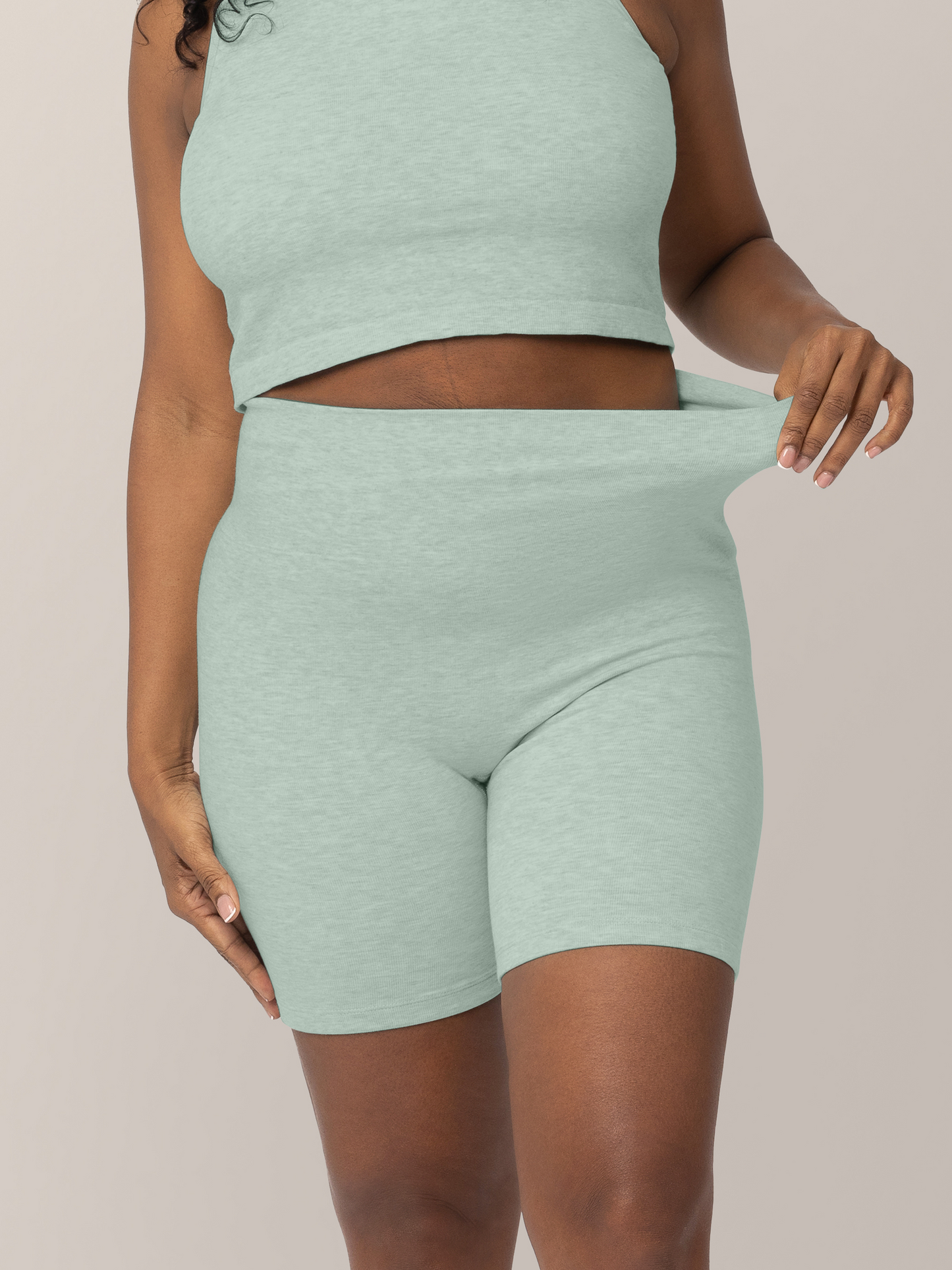 Close up of waist and stretch of fabric on the Sublime® Bamboo Maternity & Postpartum Bike Short in Dusty Blue Green Heather, on model