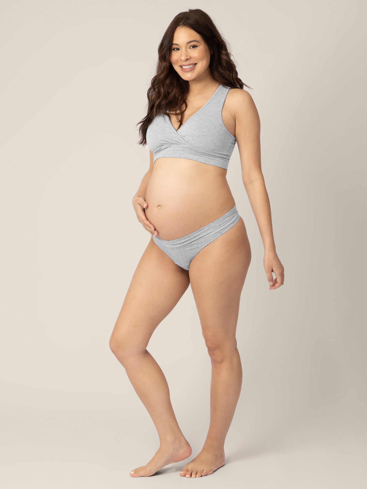 Three-quarters view of a model wearing the Bamboo Maternity & Postpartum Thong in Grey Heather